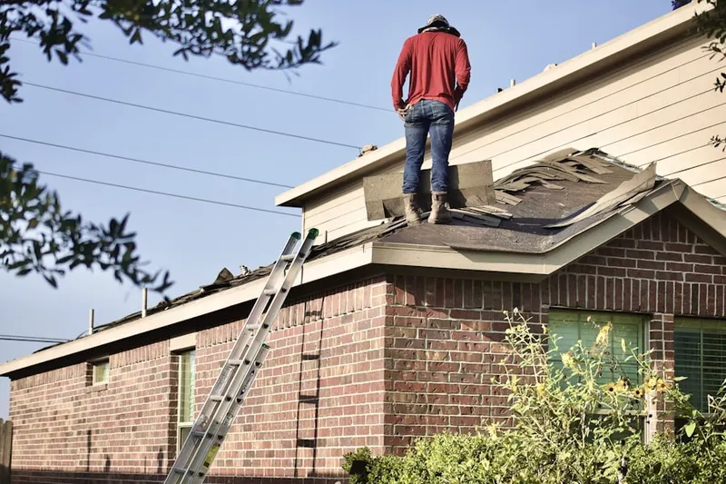 Professional roofer working on a residential roof in Woodlawn